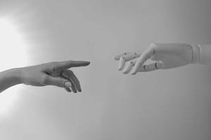 Human and robot hands almost touching